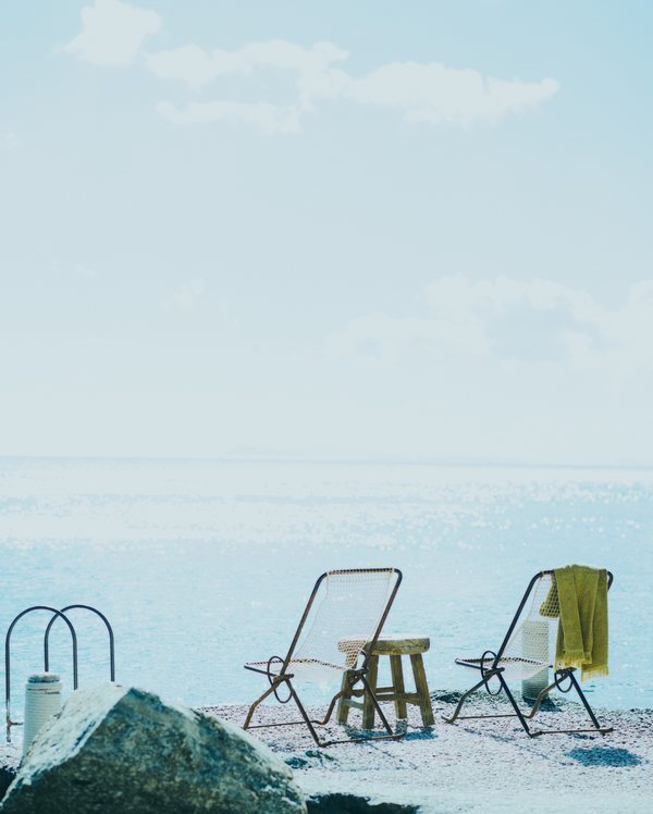 The Wild Hotel by Interni Mykonos private beach with deck chairs and sea view